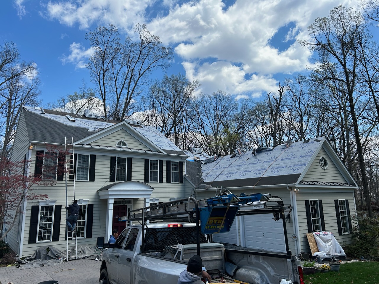 Mike's Roofing crew installing a roofing system on a Virginia home