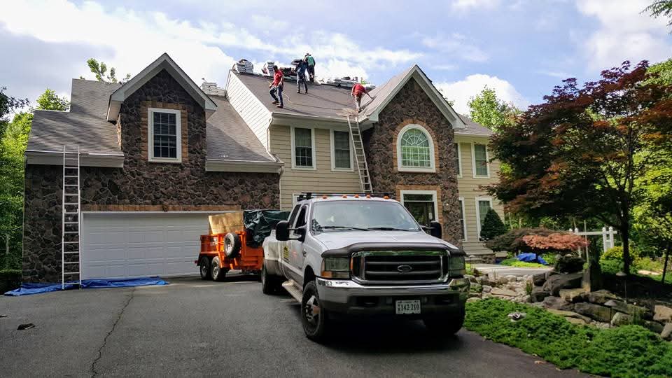 Mike's Roofing crew installing a new roof on a Virginia home